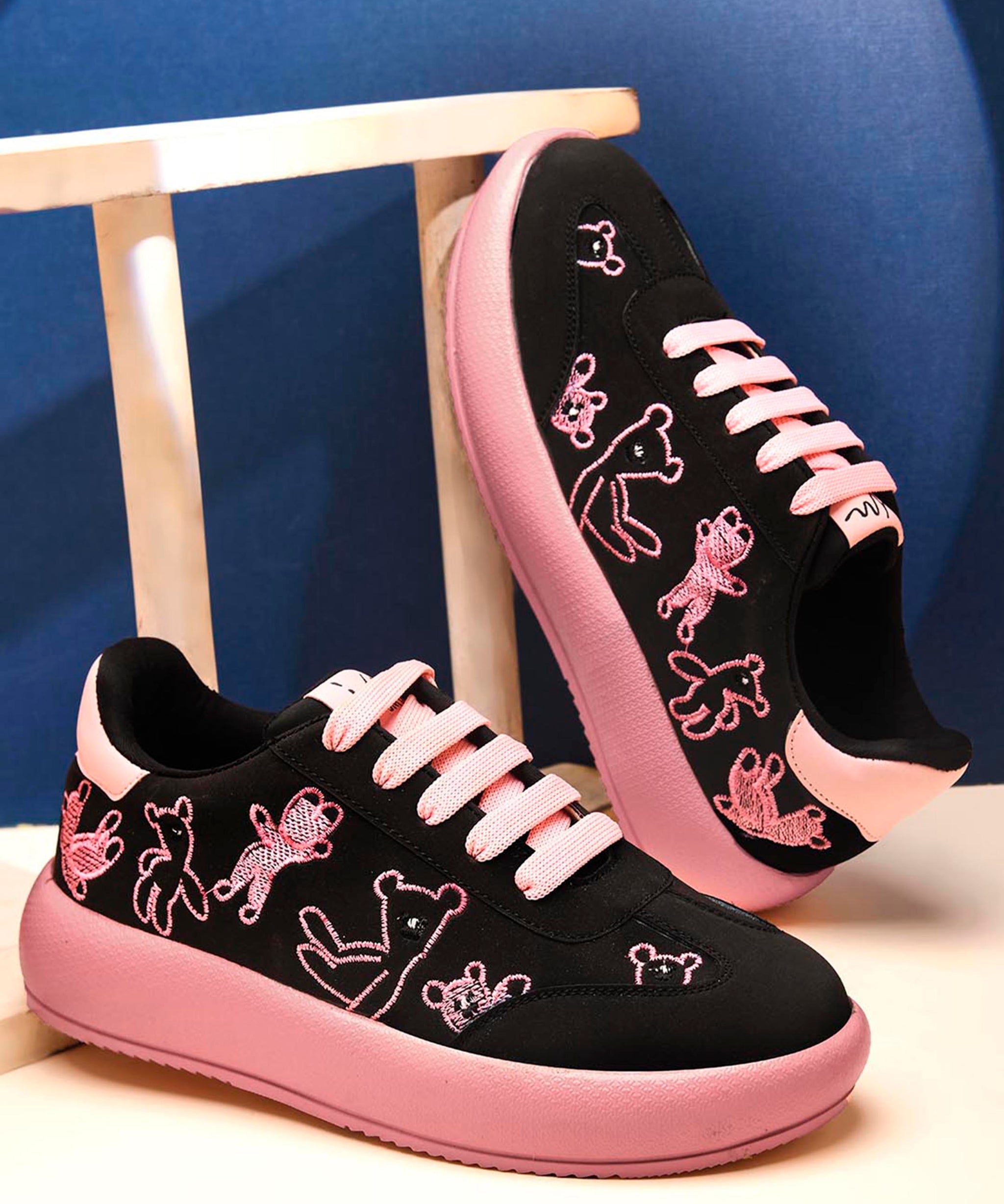 Black suede platform sneakers with brown teddy bear embroidery and dark brown laces and sole