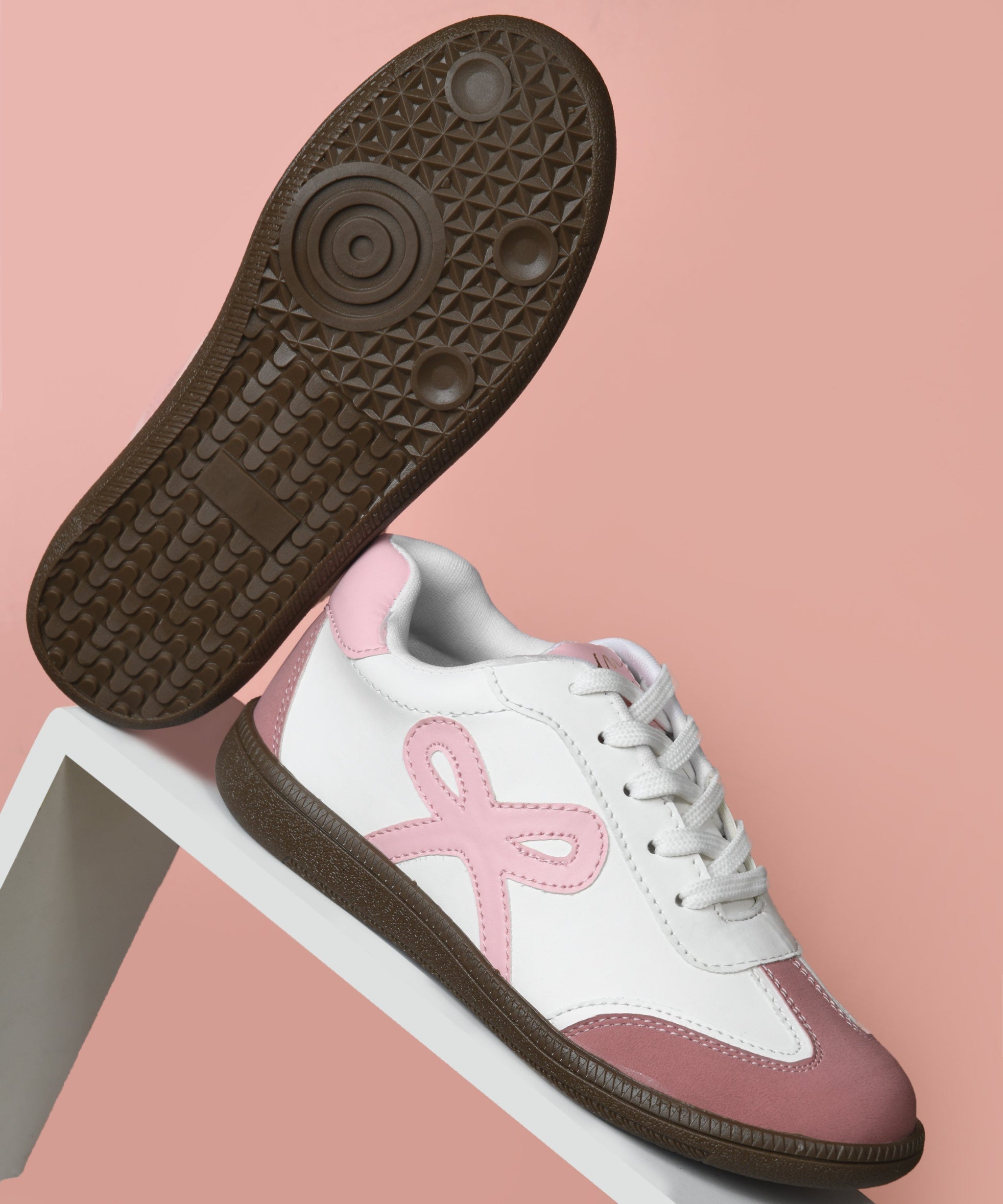 Bow sneakers for women in white pink, lace-up design featuring ribbon applique, cushioned collar, and rounded rose toe cap.