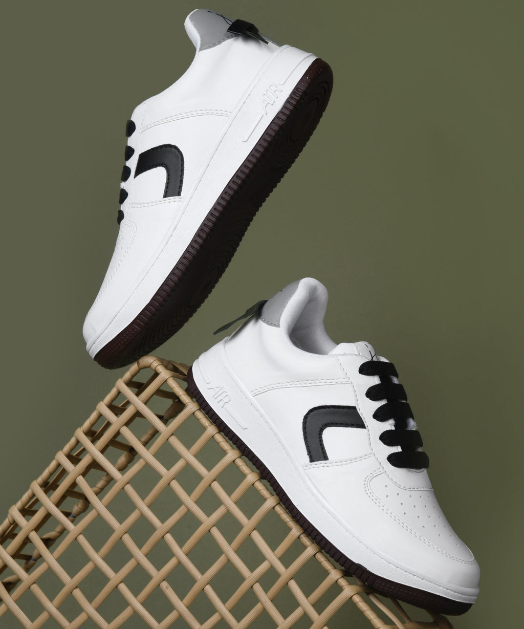 White low top sneakers women with black laces, curved side panel, perforated toe, and chunky rubber sole.