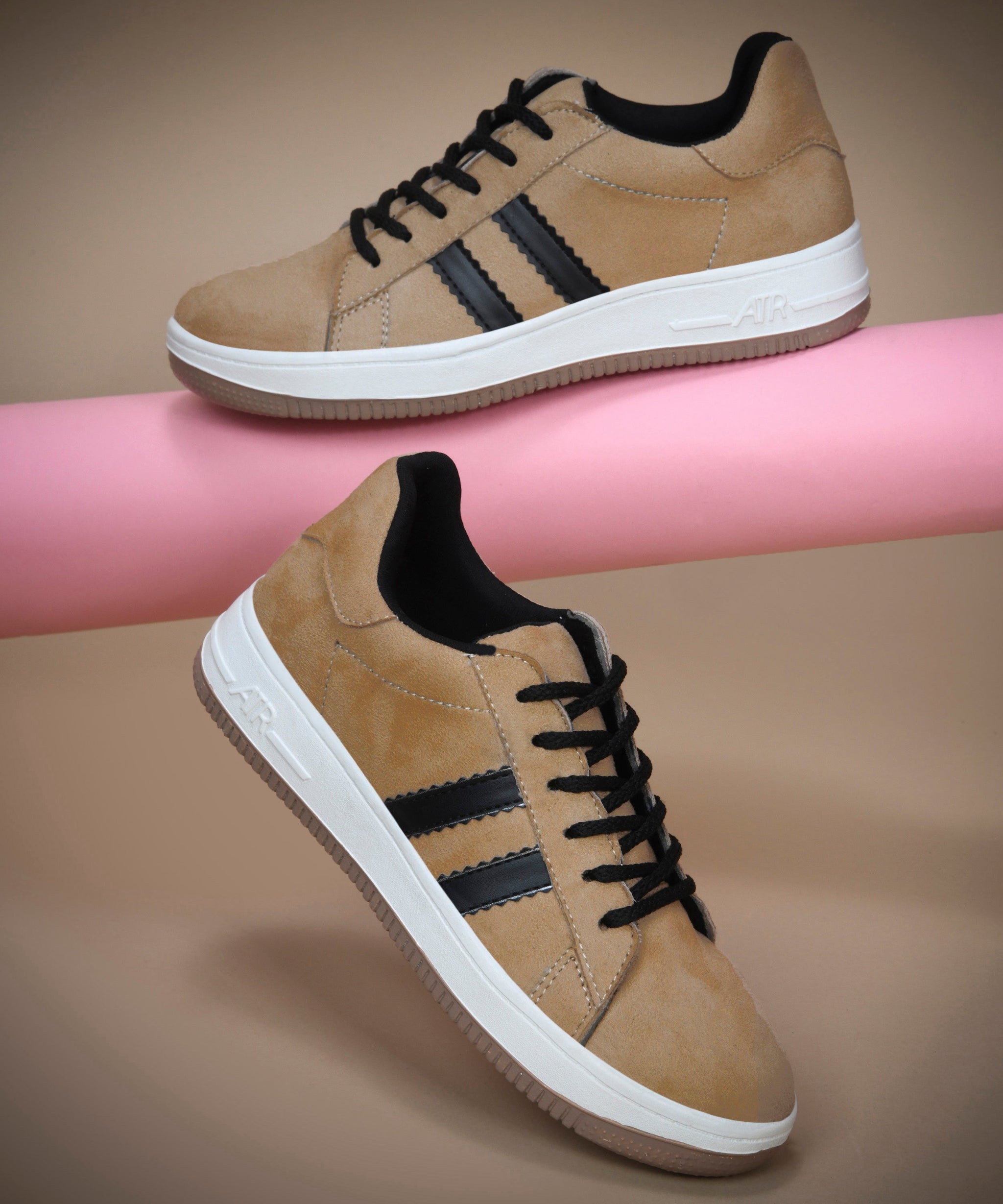 Beige suede sneakers for women featuring black side stripes, lace-up closure, white midsole, and gum outsole.