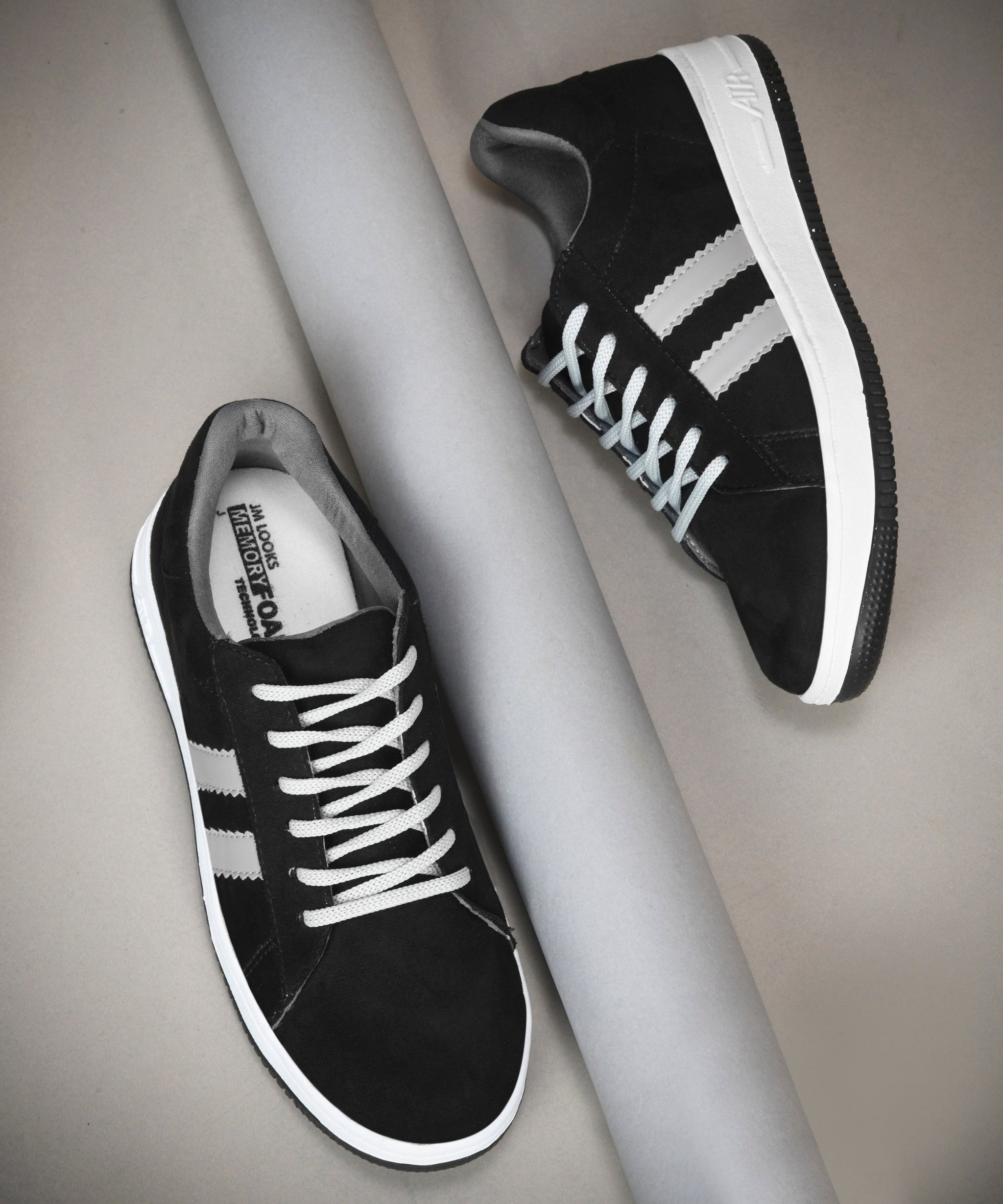 Black suede sneakers for women featuring black side stripes, lace-up closure, white midsole, and gum outsole.