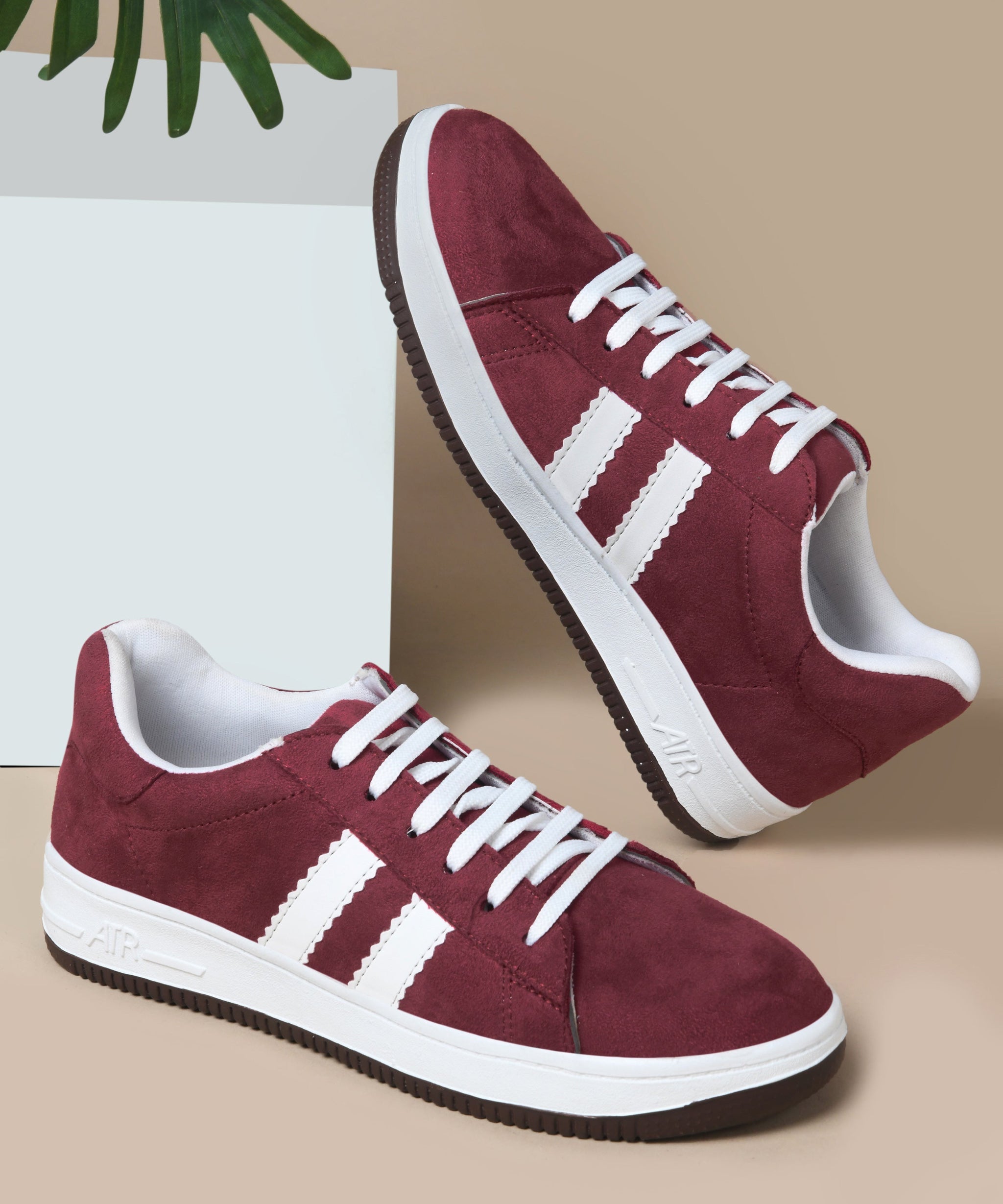 Cherry suede sneakers for women featuring black side stripes, lace-up closure, white midsole, and gum outsole.