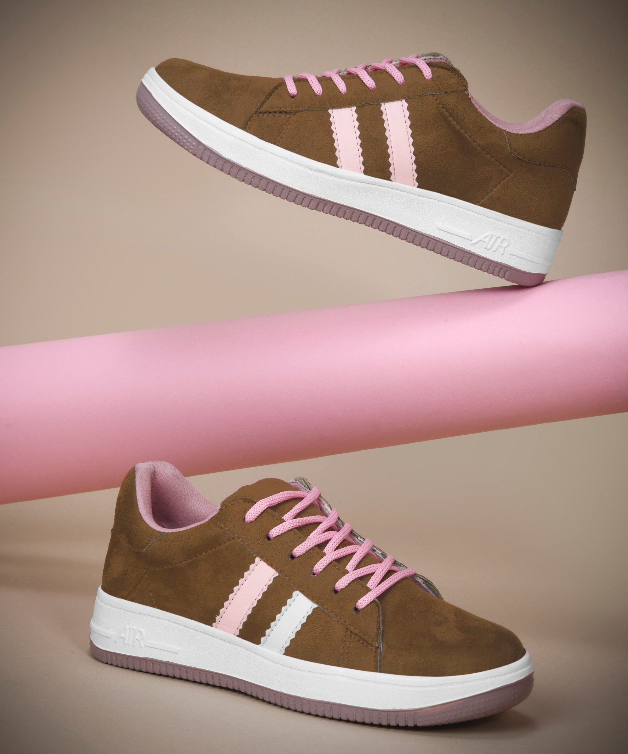 Tan suede sneakers for women featuring black side stripes, lace-up closure, white midsole, and gum outsole.