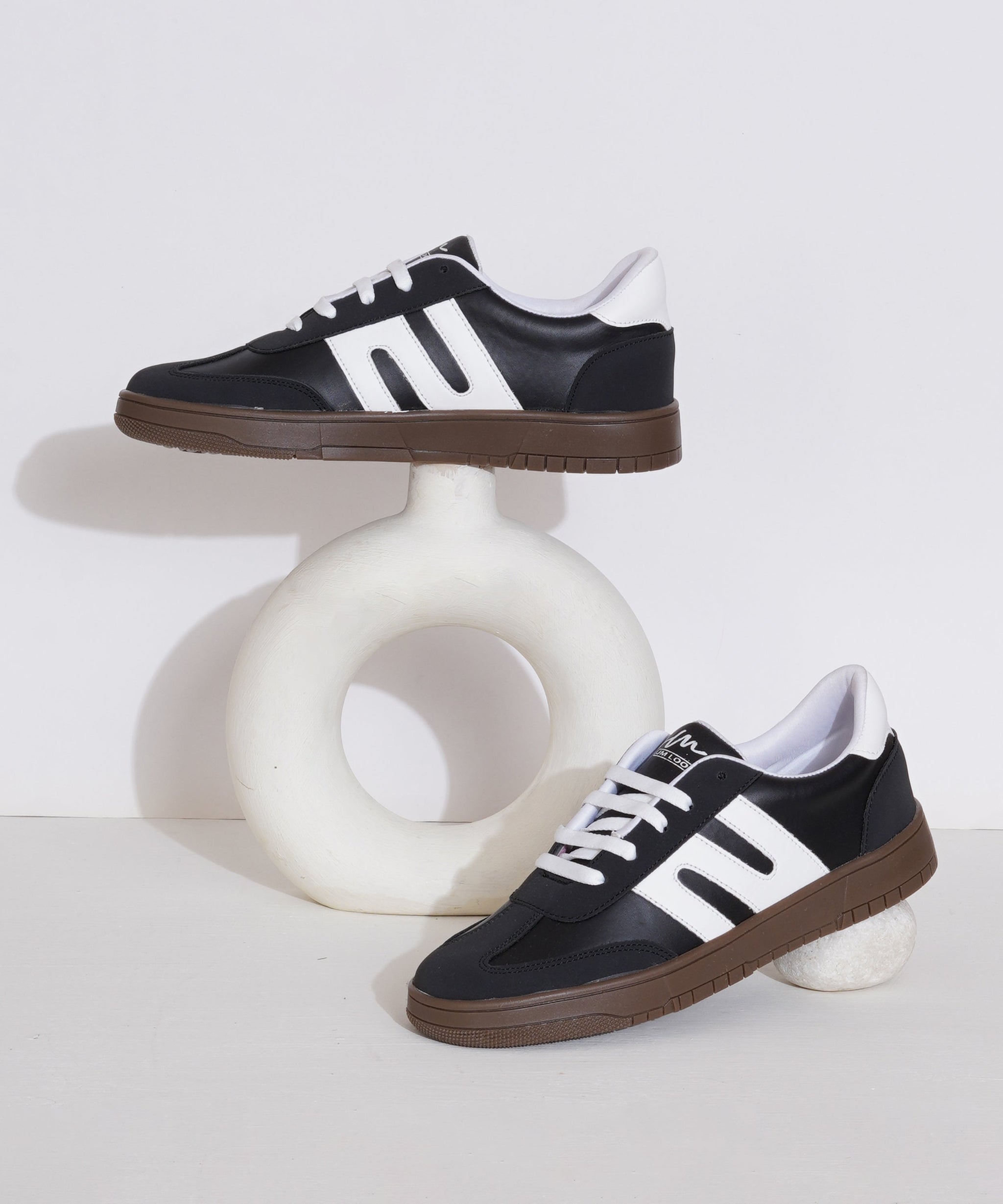 Black-White sneakers for women with white side stripe, gum sole, lace-up front, and padded collar.