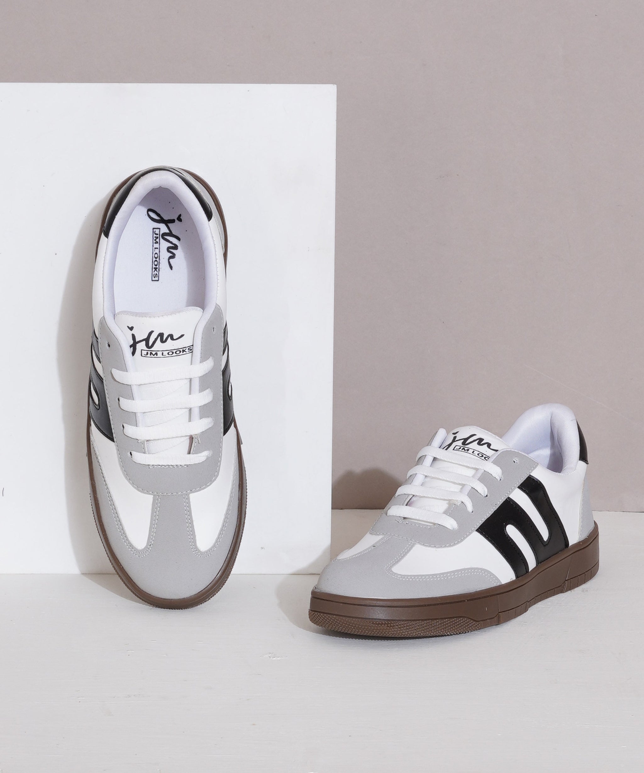 Grey-Black sneakers for women with white side stripe, gum sole, lace-up front, and padded collar.