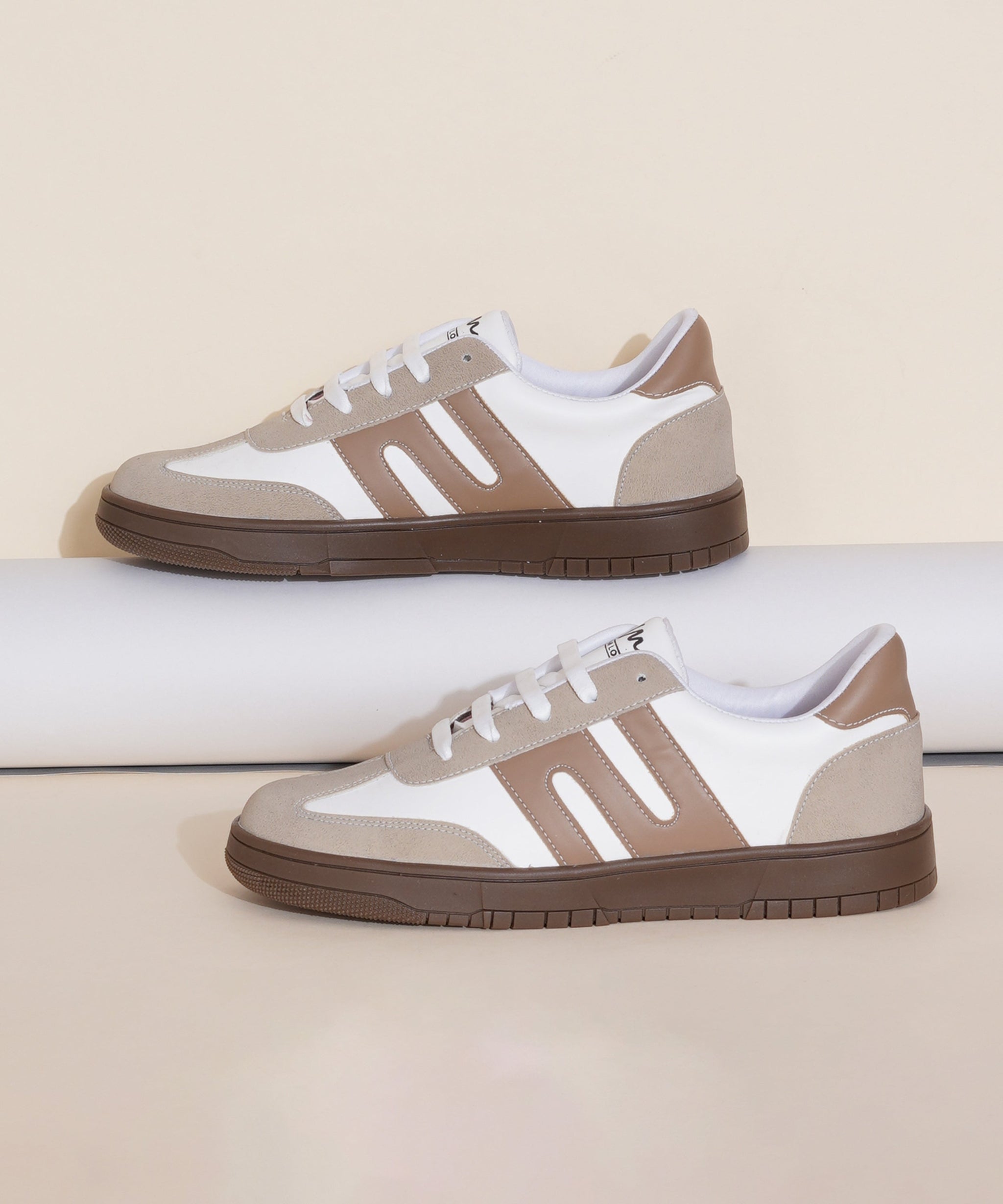 Cream-Beige sneakers for women with white side stripe, gum sole, lace-up front, and padded collar.